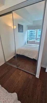 a mirror in a room with a bed at Lovely condo near Lake Ontario in Toronto