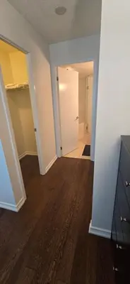 an empty living room with a hallway with a door at Lovely condo near Lake Ontario in Toronto