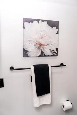 a painting of a white flower hanging on a wall at Luxurious Home Away From Home in Pickering