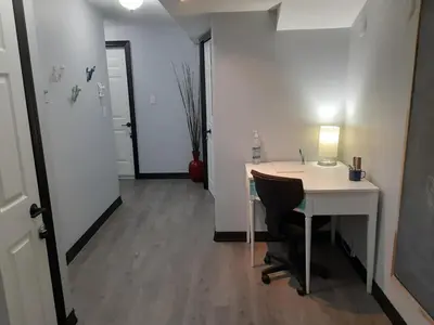a room with a desk and a table with a chair at Entire Apartment in Guelph