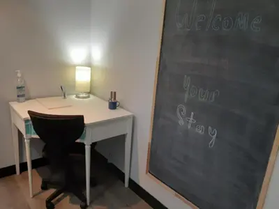a desk and a chalkboard with a desk and a chair at Entire Apartment in Guelph