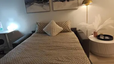 a bed in a room with a couch and a table at Reno'd Suite Steps to CN Tower - Free Parking in Toronto