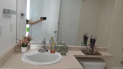 a person taking a picture of a bathroom sink at Reno'd Suite Steps to CN Tower - Free Parking in Toronto