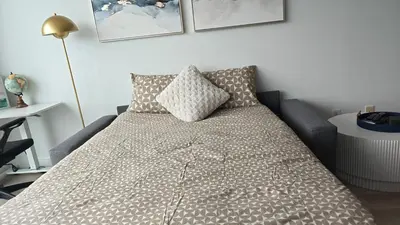 a bed with two pillows on it in a room at Reno'd Suite Steps to CN Tower - Free Parking in Toronto