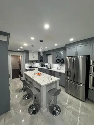 a kitchen with a large island with bar stools at Pearson Gateway Comfort Home in Mississauga