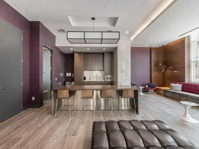 a kitchen and living room with a table and a couch at Prime Downtown Condo - St Lawrence Parking in Toronto