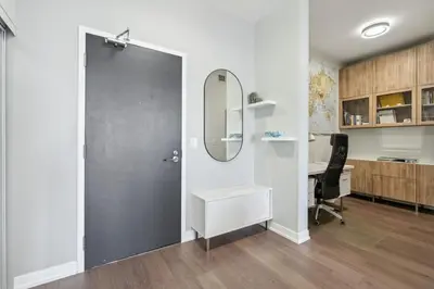 an office with a door with a desk and a mirror at Prime Downtown Condo - St Lawrence Parking in Toronto