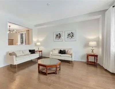 a living room with two couches and a table at Classy Home Near Beach & Airport in Hagersville