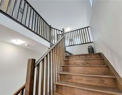a staircase in a house with wooden steps at Classy Home Near Beach & Airport in Hagersville