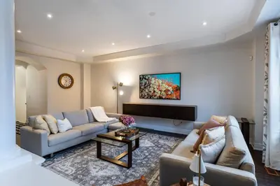 a living room with two couches and a tv at Family Retreat. in Milton