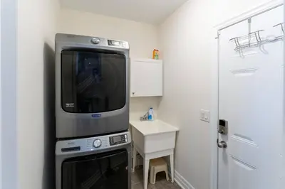 a kitchen with a microwave and a small table at Family Retreat. in Milton