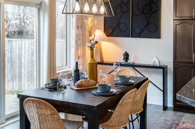 a dining room with a table with chairs and a dining room at Family Retreat. in Milton