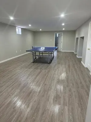 an empty room with a ping pong table in it at A getaway in Niagara from hustle bustle in Welland
