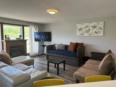a living room with a couch and a tv at A getaway in Niagara from hustle bustle in Welland