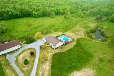 an aerial view of a house in a field with a pool at A getaway in Niagara from hustle bustle in Welland