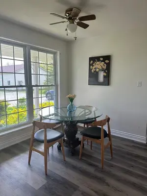 a dining room with a glass table and chairs at A getaway in Niagara from hustle bustle in Welland