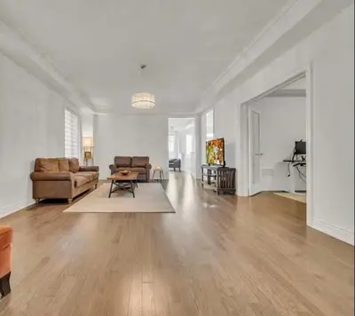 a living room with a couch and a table at Cambridge Luxury by Ravine in Cambridge