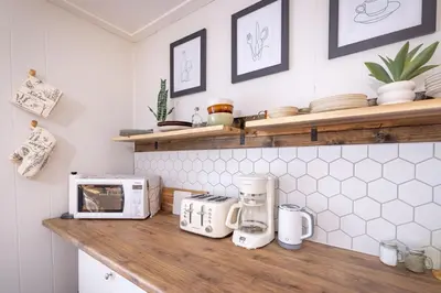 a kitchen with a counter top with a microwave at Hills Haven - Luxury Riverfront Cottage in Minden