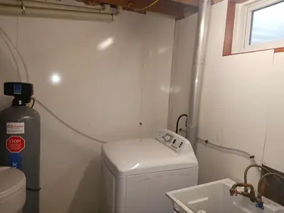 a small bathroom with a washing machine and a sink at Homestay at Heart Of Kitchener-Free Wifi & Parking in Kitchener