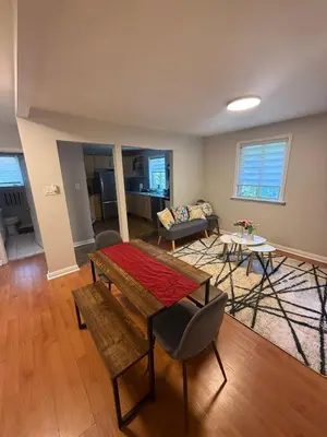 a living room with a table and a couch at \u9a6c\u5361\u59c6\u7684\u5bc4\u5bbf\u5bb6\u5ead- Simple Trip To Toronto in Markham