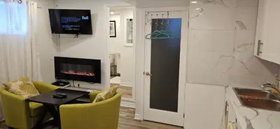 a living room with a table and chairs and a television at Walk out Basement Studio in Smithville