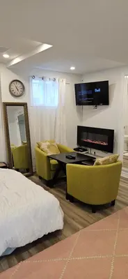 a bedroom with a bed and a table and chairs at Walk out Basement Studio in Smithville