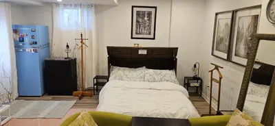 a bedroom with a bed and a cross on the wall at Walk out Basement Studio in Smithville
