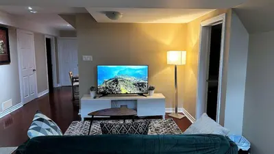 a living room with a couch and a flat screen tv at 2 Bed-2Bath-Kitchen Private Family Couple Work in Newmarket