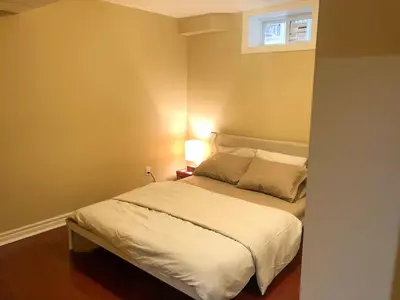 a small bedroom with a bed with a window at 2 Bed-2Bath-Kitchen Private Family Couple Work in Newmarket