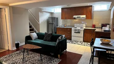 a living room with a green couch in a kitchen at 2 Bed-2Bath-Kitchen Private Family Couple Work in Newmarket