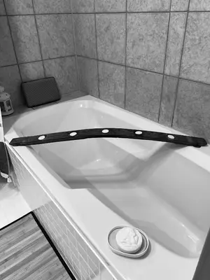 a bath tub with a black belt around it at Country Roads Dwelling in Hamilton