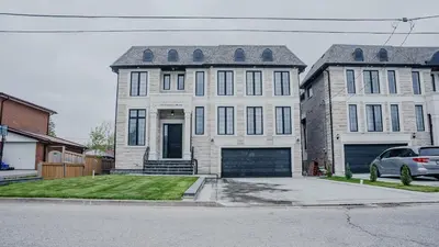 a white house with a car parked in front of it at Upscale Pickering Escape Near Lake & Dining in Pickering