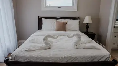 a bed with two heart shaped towels on it at Upscale Pickering Escape Near Lake & Dining in Pickering