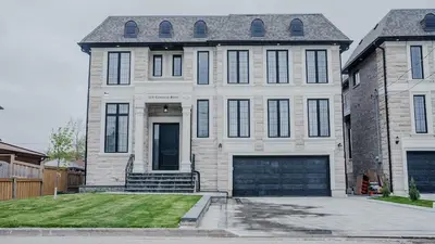 a large white house with a large garage at Upscale Pickering Escape Near Lake & Dining in Pickering