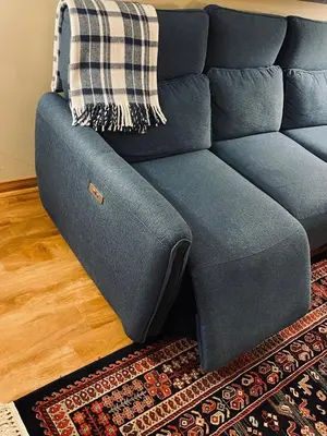 a blue couch sitting in a living room at Country Roads Dwelling in Dundas