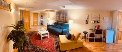 a living room with a blue couch and a table at Country Roads Dwelling in Dundas