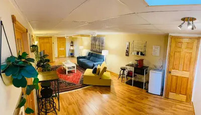 a living room with a blue couch and a kitchen at Country Roads Dwelling in Dundas