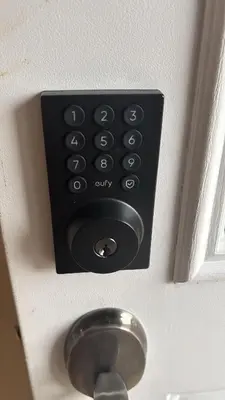 a black remote control on a door with a knob at Budget Stay In Heart of Waterloo-Free Wifi-Parking in Waterloo
