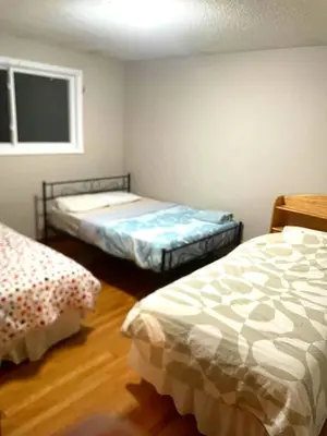 a bedroom with two beds and a window at Budget Stay In Heart of Waterloo-Free Wifi-Parking in Waterloo