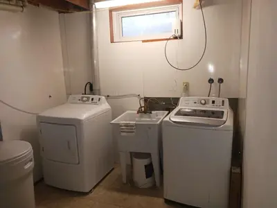 a small kitchen with a stove and a washer at Budget Stay In Heart of Waterloo-Free Wifi-Parking in Waterloo