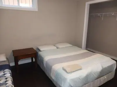 a small bedroom with a bed and a table at Budget Stay In Heart of Waterloo-Free Wifi-Parking in Waterloo