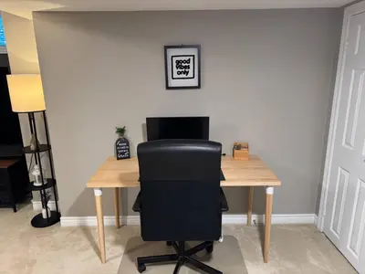 a black chair sitting at a wooden desk at Vibrant and Comfy Mississauga Home 20 mins from YYZ in Mississauga