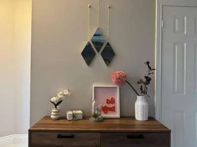a table with a picture and flowers on it at Vibrant and Comfy Mississauga Home 20 mins from YYZ in Mississauga