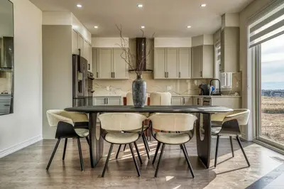 a kitchen with a dining room table and chairs at Youngs Cove Chalet in Prince Edward County in Carrying Place