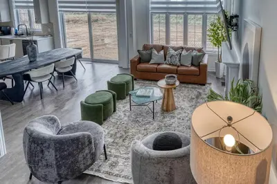 a living room with couches and chairs and a table at Youngs Cove Chalet in Prince Edward County in Carrying Place