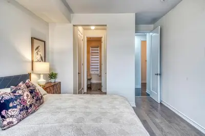 a bedroom with a bed and a hallway at Youngs Cove Chalet in Prince Edward County in Carrying Place