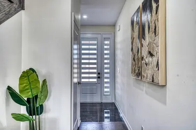 a hallway with a door and a potted plant at Youngs Cove Chalet in Prince Edward County in Carrying Place