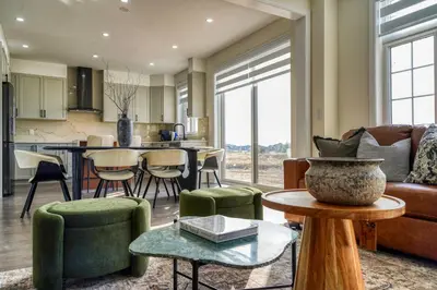 a living room with a couch and a table at Youngs Cove Chalet in Prince Edward County in Carrying Place