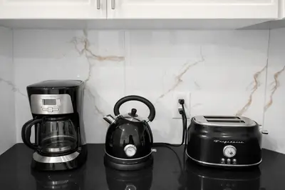a coffee maker and a toaster on a kitchen counter at Newly Renovated 3BR Orangeville Basement Suite with Private Access, 10 Min Walk to Headwaters Hospital, 5 Min Drive to Mount Alverno! Ideal for Medical Stay, Family Travel & Work Trips! in Orangeville