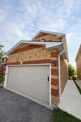 a brick house with a white garage door at Newly Renovated 3BR Orangeville Basement Suite with Private Access, 10 Min Walk to Headwaters Hospital, 5 Min Drive to Mount Alverno! Ideal for Medical Stay, Family Travel & Work Trips! in Orangeville